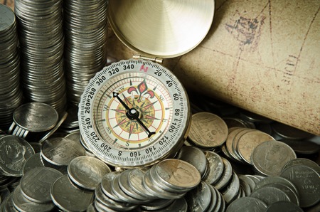 compass and coins on old mapの写真素材