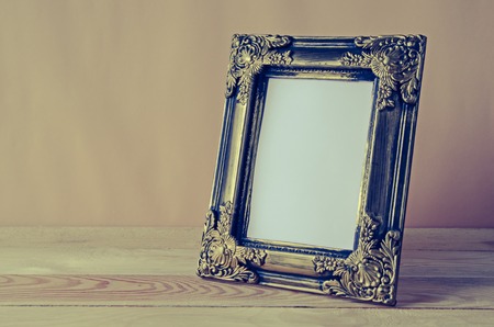 blank photo frame on wooden tableの写真素材