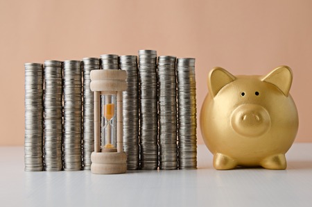 coin stack with compass and piggy bank , Saving plan