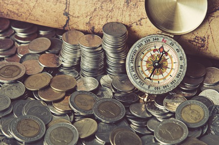 compass and coins on old mapの写真素材