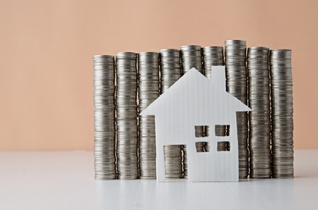 House model and stack of coinの写真素材