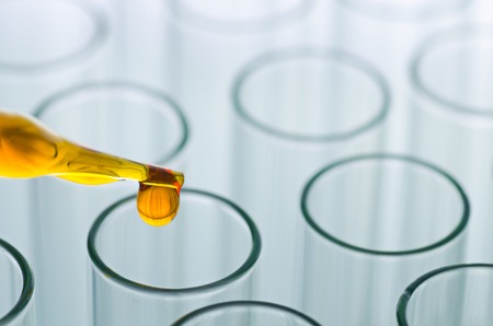 science laboratory pipette with drop on test tube background , laboratory conceptの写真素材