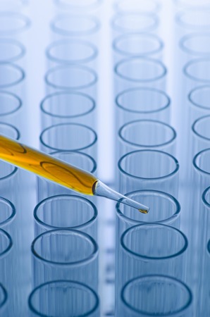 science laboratory pipette with drop on test tube background , laboratory conceptの写真素材