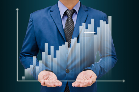 businessman with growing graph on virtual screenの写真素材