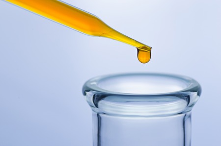 science laboratory pipette with drop on test tube background , laboratory conceptの写真素材