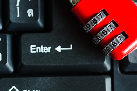 red metal security lock on keyboardの写真素材