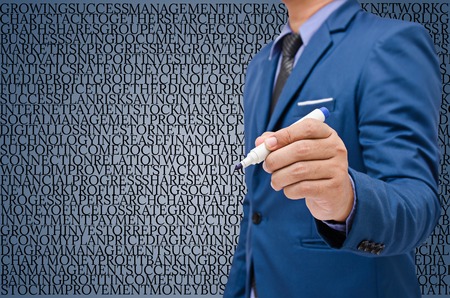 businessman write on virtual screen with alphabetical backgroundの写真素材