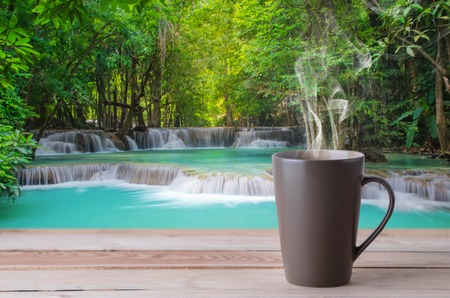 coffee cup with smoke on waterfall backgroundの写真素材