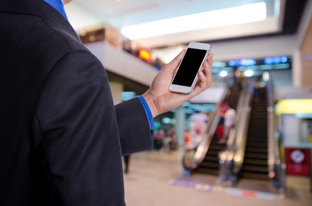 business man holding tablet in hand in event background