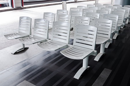 white public chairs waiting for passengerの写真素材