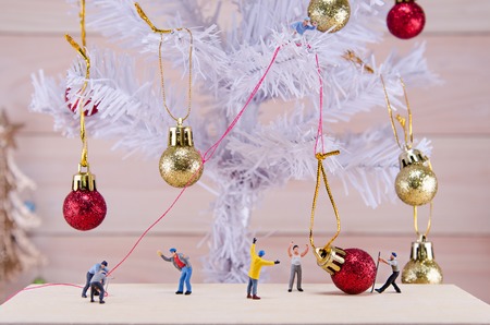 miniature people try to ornament Christmas treeの写真素材