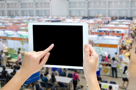woman hand holding the phone tablet on blur event background