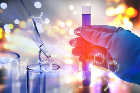 Double exposure of scientist hand holding laboratory test tubeの写真素材