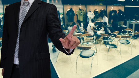 business man touch visual screen with blurred event backgroundの写真素材