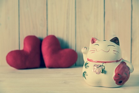 lucky cat with couple heart backgroundの写真素材
