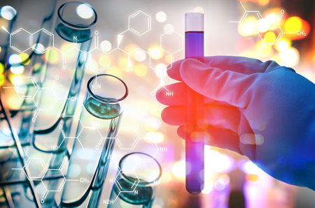 Double exposure of scientist hand holding laboratory test tubeの写真素材