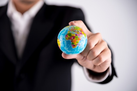 globe in businessman handの写真素材