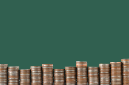 stack of coins on green board backgroundの写真素材