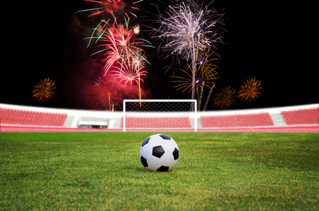 Soccer ball on the field with firework backgroundの写真素材