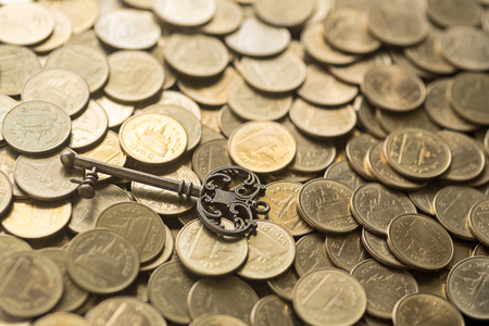 skeleton key lying on gold coinsの写真素材