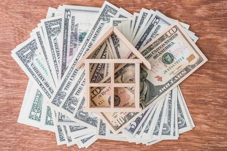 wood house model on dollar moneyの写真素材