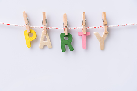 wood text PARTY hanging with clothespins on light blue wooden backgroundの写真素材