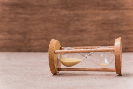 vintage sandglass on wooden table
