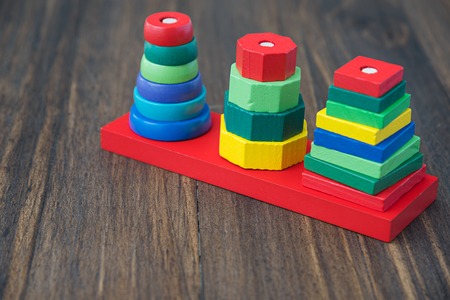 stack of many shape cube building blocks on wooden table , children toyの写真素材