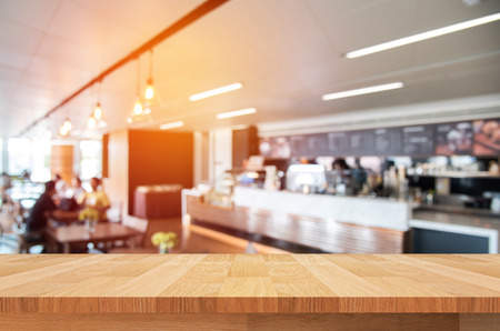 wood shelf on abstract blurred people in coffee shop backgroundの写真素材
