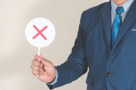 business man holding small white circle board with false sign