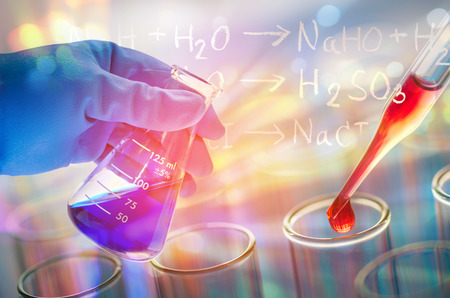 science hand holding laboratory test tubes , laboratory equipment , science background