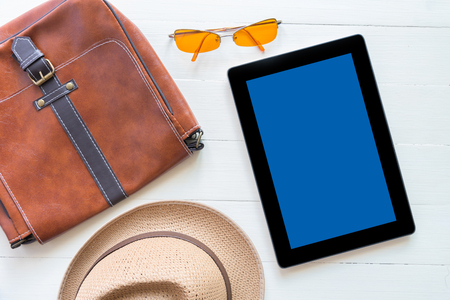 tablet and flat lay of men's casual fashion on white wooden floorの写真素材