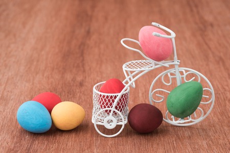 easter eggs decorated in white miniature bicycleの写真素材
