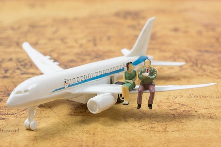 couple miniature people on a planeの写真素材