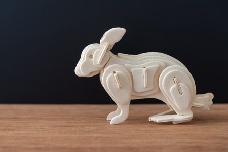 wooden rabbit model on table and black backgroundの写真素材