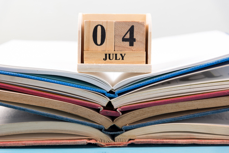 wood calendar for 4 july on open book stackの写真素材