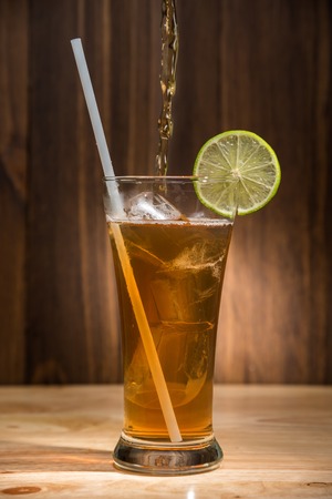 ice tea glass on wooden tableの写真素材