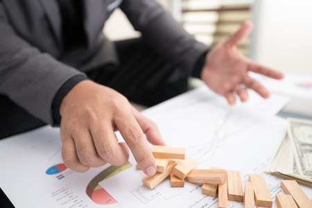 businessman fails building up wood block towerの写真素材