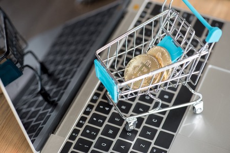 Cryptocurrency golden bitcoin coin in shopping cart, digital currency conceptの写真素材