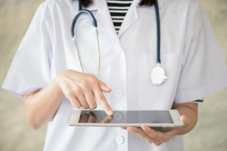 woman doctor finger touch on tablet screenの写真素材