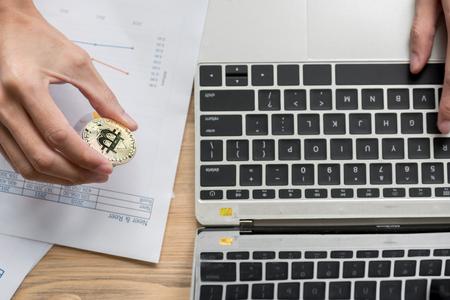 Cryptocurrency golden bitcoin coin in man hand , digital currencyの写真素材