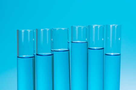 Science laboratory test tubes on light blue background , laboratory equipmentの写真素材