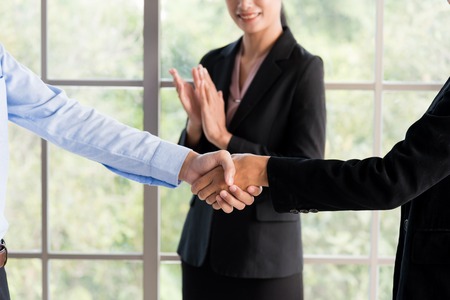 business man and women are shaking hand