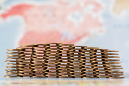 coins stack on world map background.の写真素材