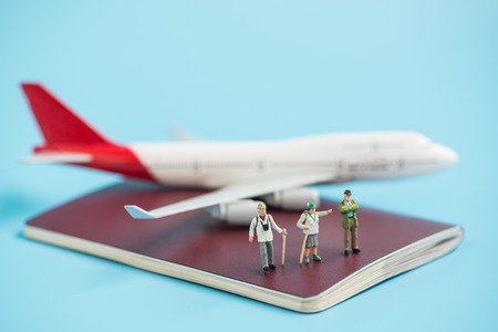 miniature traveler and airplane model on passport bookの写真素材