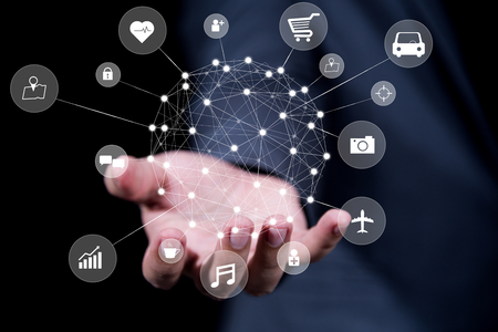 businessman hand holding virtual  globe of internet of things (IoTs) technologyの写真素材