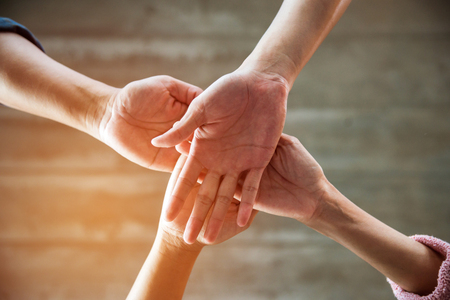 people join their hands together showing teamwork powerの写真素材