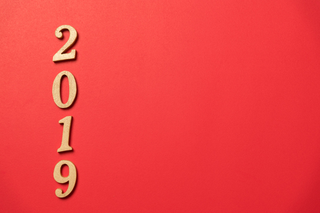 wood text year 2019 on red background for happy new yearの写真素材
