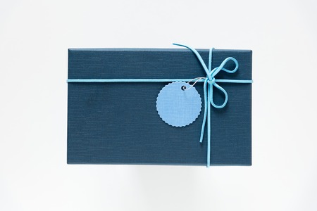 blue giftbox with light bow strip on white background , top viewの写真素材