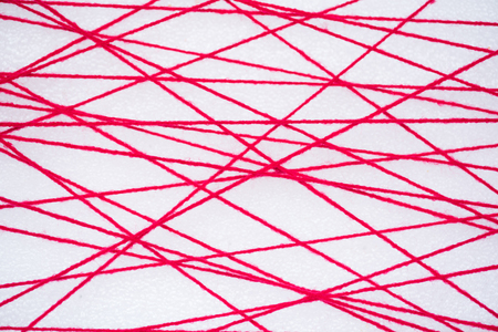abstract web line connection of complex and heap red color yarn  on white background , networking conceptの写真素材